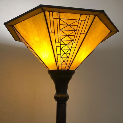 Sale Photo Thumbnail #38: Mission or Arts and Crafts style floor lamp with an illuminated yellow glass shade featuring a geometric pattern.