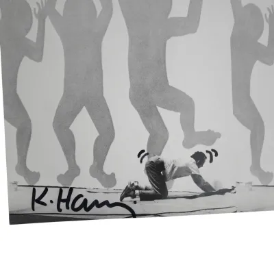 Sale Photo Thumbnail #178: KEITH HARING SIGNED 1986 CATALOGUE PHOTO WITH DRAWN EMBELLISHMENTS