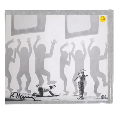 Sale Photo Thumbnail #176: KEITH HARING SIGNED 1986 CATALOGUE PHOTO WITH DRAWN EMBELLISHMENTS