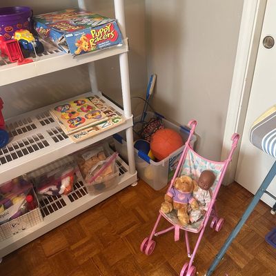 Sale Photo Thumbnail #63: Selection of children's toys including wooden puzzles, board games like Puppy Racers, building blocks, sports balls, and a toy pink stroller with dolls.