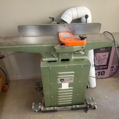 Sale Photo Thumbnail #17: Grizzly stationary jointer machine mounted on a Shop Fox mobile base with attached dust collection elbow.
