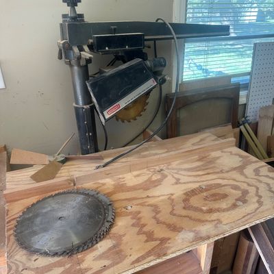 Sale Photo Thumbnail #19: Craftsman radial arm saw mounted on a plywood worktable, complete with an extra Hitachi saw blade.