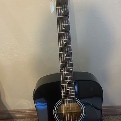 Sale Photo Thumbnail #32: Stadium brand full-size dreadnought acoustic-electric guitar with a glossy black finish and chrome hardware.