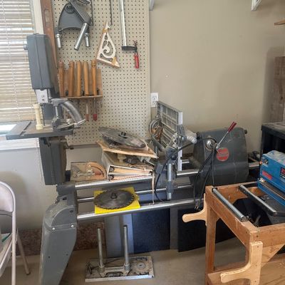 Sale Photo Thumbnail #4: Vintage Shopsmith Mark V multi-purpose woodworking machine with various accessories, band saw attachment, saw blades, and wood turning chisels.