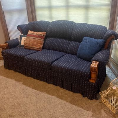 Sale Photo Thumbnail #9: Country-style three-cushion sofa featuring dark blue striped upholstery with a pleated skirt and exposed wooden arm trim.