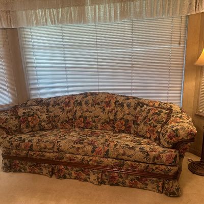 Sale Photo Thumbnail #45: Vintage floral tapestry sofa with wood trim and matching accent pillows, paired with an ornate floor lamp with a fabric shade.