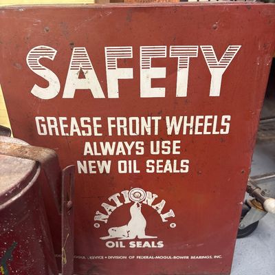 Sale Photo Thumbnail #27: Vintage mid-century National Oil Seals metal advertising sign or cabinet door, featuring a red painted finish with bold white lettering and seal logo.