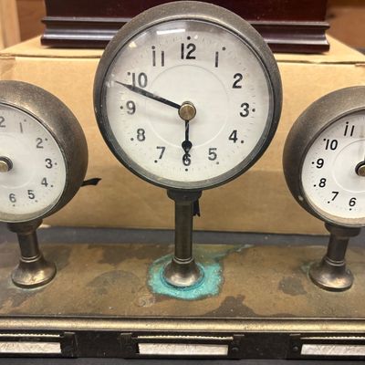 Sale Photo Thumbnail #7: Vintage brass triple desk clock featuring three round gauge-style clock faces mounted on a single rectangular base with label holders.