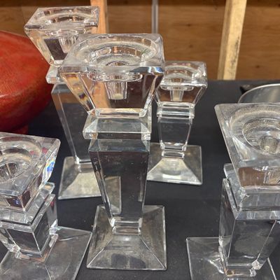 Sale Photo Thumbnail #6: Set of clear crystal taper candlestick holders featuring geometric, square-cut column designs, shown alongside a red glaze ceramic vessel.