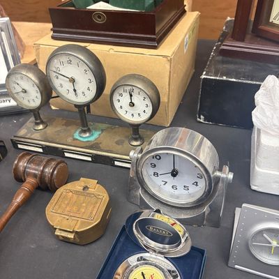 Sale Photo Thumbnail #11: Collection of desk accessories including a vintage three-dial World Time clock, a chrome gimbal maritime clock, a boxed Dalvey pocket compass, and a wooden gavel.