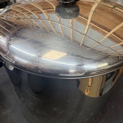 Sale Photo Thumbnail #18: Vintage Revere Ware stainless steel stockpot with copper bottom and black Bakelite lid knob.