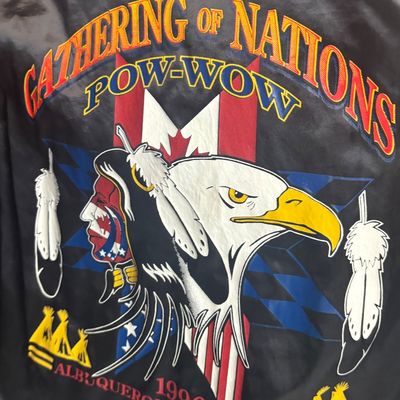Sale Photo Thumbnail #33: Vintage 1996 Gathering of Nations Pow-Wow black satin jacket featuring colorful embroidered Native American and bald eagle graphics.