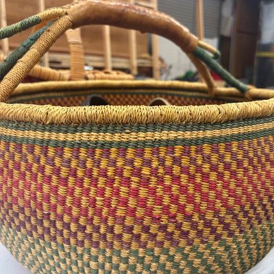 Sale Photo Thumbnail #44: Handwoven Bolga market basket with a leather-wrapped handle, featuring colorful geometric pattern in natural, green, and pink dyes.