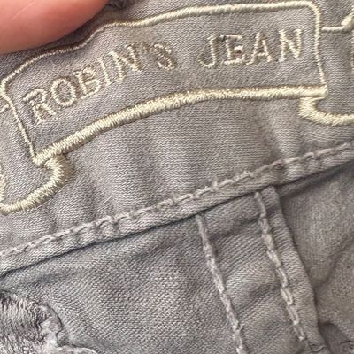 Sale Photo Thumbnail #38: Embroidered Robin's Jean logo scroll detail on the waistband of grey denim jeans.
