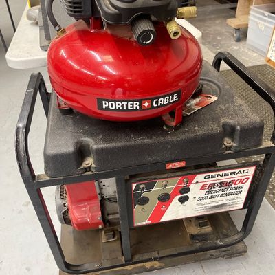 Sale Photo Thumbnail #56: Red Porter-Cable pancake air compressor resting on top of a Generac 5000-watt emergency power generator.