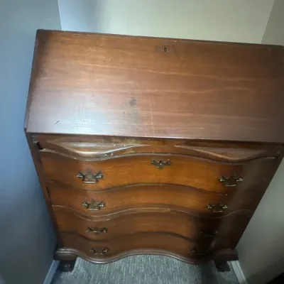 Vintage Chippendale style slant-front secretary desk with serpentine drawer fronts and brass batwing hardware.
