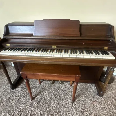 Vintage dark wood upright Weaver piano with matching wooden bench.