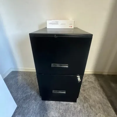 Black metal two-drawer filing cabinet featuring plastic bar handles and a key lock.