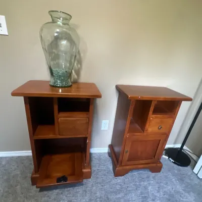 Pair of matching cherry-finished wooden nightstands featuring open cubbies, small drawers, and bottom cabinet storage.