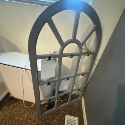 Arched windowpane-style decorative wall display frame in a grey finish, featuring small black clips for photos or notes.