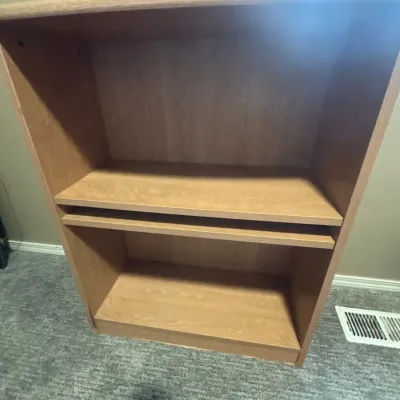 Light oak finish wood laminate bookshelf with adjustable shelving.