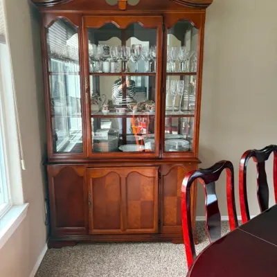 Traditional cherry wood china cabinet featuring glass-front upper display shelves and lower cabinet storage.