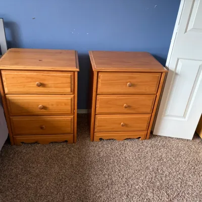Matching pair of traditional three-drawer nightstands with wooden knobs