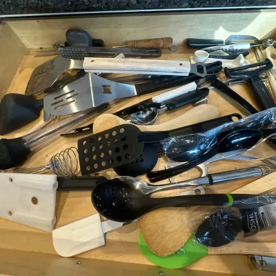 kitchen utensils, including spatulas, spoons, tongs, and a whisk.