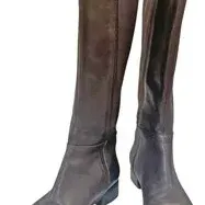 Pair of women's dark grey knee-high boots featuring leather lower foot sections, suede upper shafts, low heels, and side zipper...