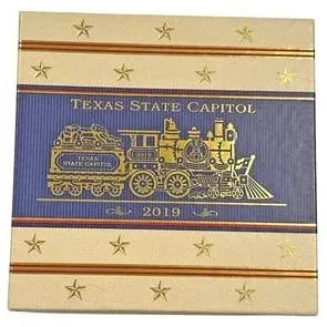 Official 2019 Texas State Capitol collectible Christmas ornament box featuring a gold steam locomotive design on a blue and cream...