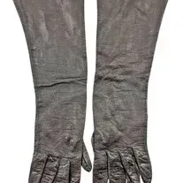 Pair of vintage long opera-length dark leather or suede gloves showing light wear and creasing.