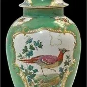 Antique Chinese export-style porcelain ginger jar with cover, featuring a green ground, gilt accents, and painted pheasant reserves.