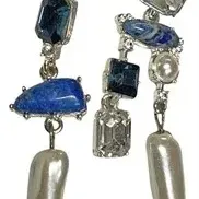 Pair of contemporary asymmetrical drop earrings featuring blue stones, clear crystals, and elongated baroque freshwater pearls.