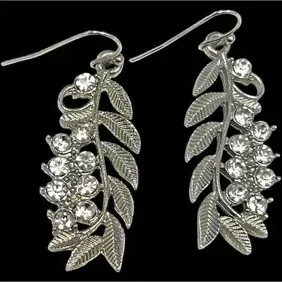 Pair of silver-tone dangle earrings with leaf motifs and clear rhinestone accents on French wire hooks.