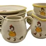 Vintage child's ceramic tea set featuring a girl pulling a toy duck decal on white pottery with yellow trim, including sugar,...