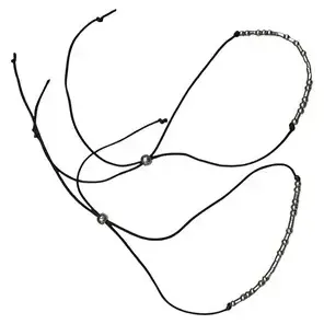 Pair of Morse code beaded cord bracelets with sliding adjustable closures.