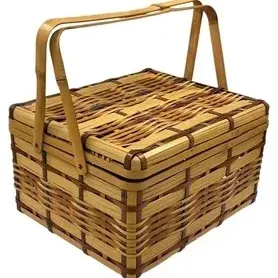 Vintage woven wicker picnic basket with double handles and a split lid.