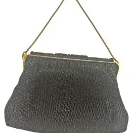 Vintage black beaded evening bag featuring a gold-tone clasp frame and chain strap.