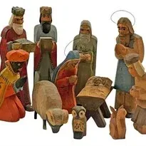 Vintage hand-carved painted wooden Nativity set featuring figures, animals, and baby Jesus in a manger.