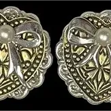 Pair of vintage two-tone clip-on earrings featuring a textured heart motif with silver-tone ribbons and faux pearl centers.