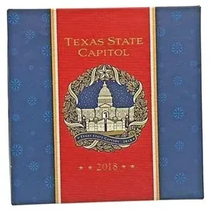 Official 2018 Texas State Capitol holiday ornament in original blue and red decorative packaging.