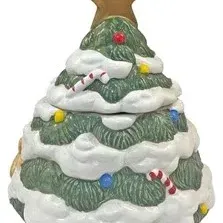 Vintage ceramic Christmas tree cookie jar featuring molded snow details, festive candy canes, colored ornaments, and a gold star finial.