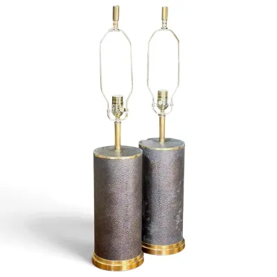 Sale Photo Thumbnail #189: Pair of mid-century modern cylindrical table lamps featuring textured shagreen-style bases trimmed with brass accents and brass harps.