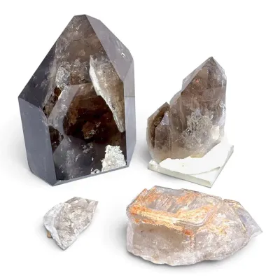 Sale Photo Thumbnail #176: Collection of four smoky quartz and clear quartz mineral specimens, including a large polished point tower and natural cluster specimens.