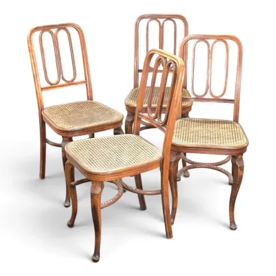 Sale Photo Thumbnail #132: Set of four antique bentwood side chairs with cane seats and looped splat backs.