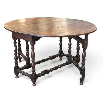 Sale Photo Thumbnail #155: Jacobean-style oak gateleg drop-leaf table with turned legs and stretcher, showing light surface wear.