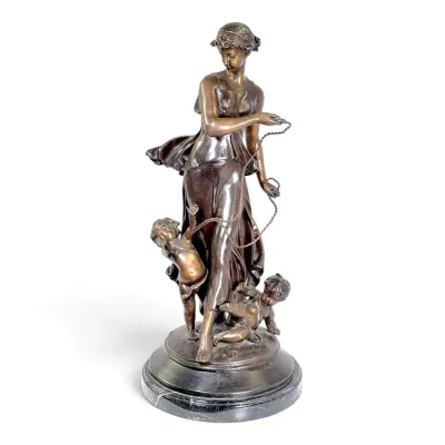 Sale Photo Thumbnail #198: Antique bronze statue depicting a classical woman with two cherubs, titled 'L'Innocence', mounted on a round marble base.