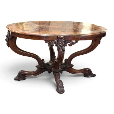 Sale Photo Thumbnail #156: Ornate antique carved wood center table featuring a high-gloss polished top, intricate floral carvings, and curved cabriole-style legs with a sculpted pedestal base.
