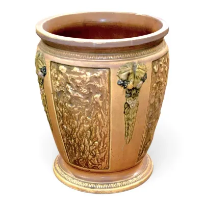Sale Photo Thumbnail #192: Antique glazed ceramic planter featuring relief-molded panels and grape cluster accents around the sides.