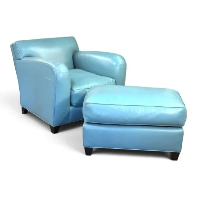 Sale Photo Thumbnail #149: Light blue leather club chair and matching ottoman set featuring rolled arms, dark block feet, and subtle wear consistent with age.